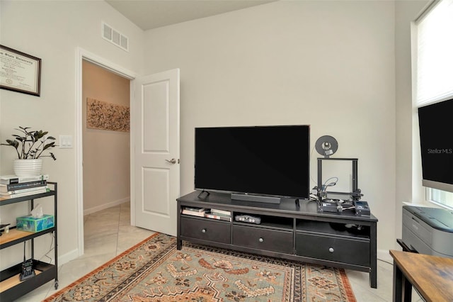 living room with visible vents, baseboards, and light tile patterned flooring