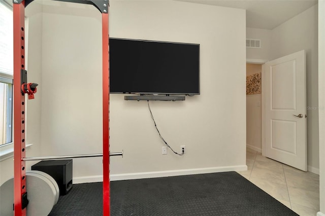 exercise area with tile patterned floors, visible vents, and baseboards