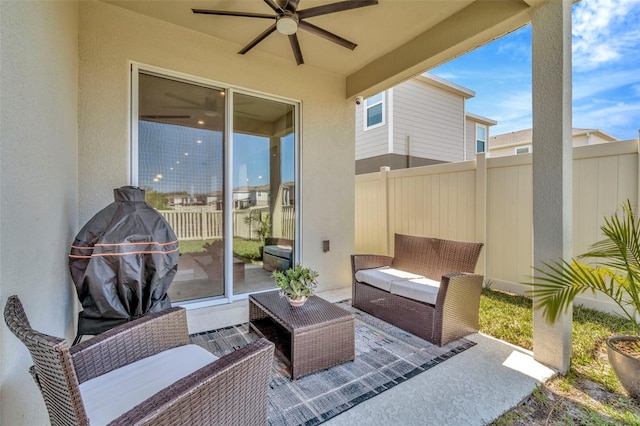 view of patio with outdoor lounge area, fence, and ceiling fan