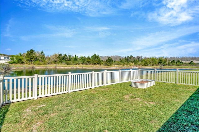 view of yard featuring fence and a water view