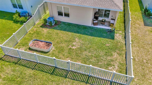 exterior space featuring cooling unit, a fenced backyard, and a patio area