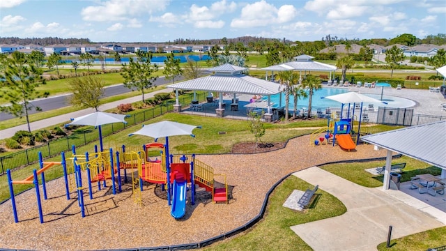 community playground featuring a gazebo, a lawn, and fence