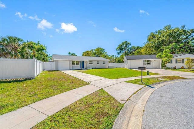 single story home with concrete driveway, a front lawn, an attached garage, and fence