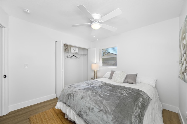 bedroom with ceiling fan, a closet, baseboards, and wood finished floors