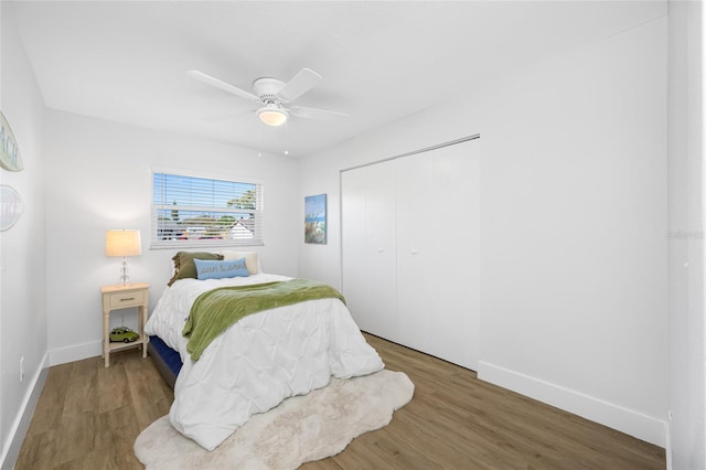 bedroom featuring a closet, baseboards, and wood finished floors