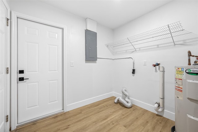 laundry room featuring hookup for a washing machine, light wood-style flooring, laundry area, water heater, and electric panel