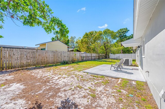 view of yard with central AC, a patio, and a fenced backyard