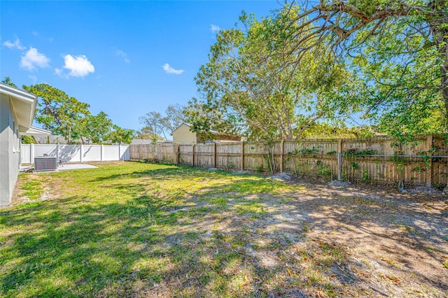 view of yard featuring central air condition unit and a fenced backyard