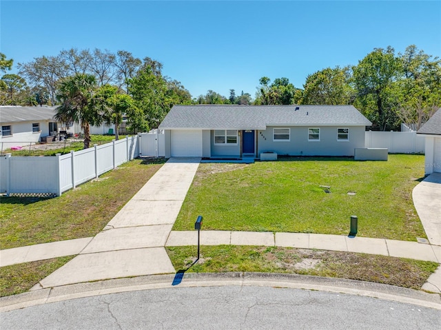 view of front of house featuring concrete driveway, a front lawn, an attached garage, and fence private yard