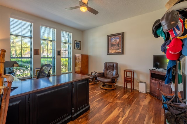 office with dark wood finished floors, a ceiling fan, baseboards, and a textured ceiling