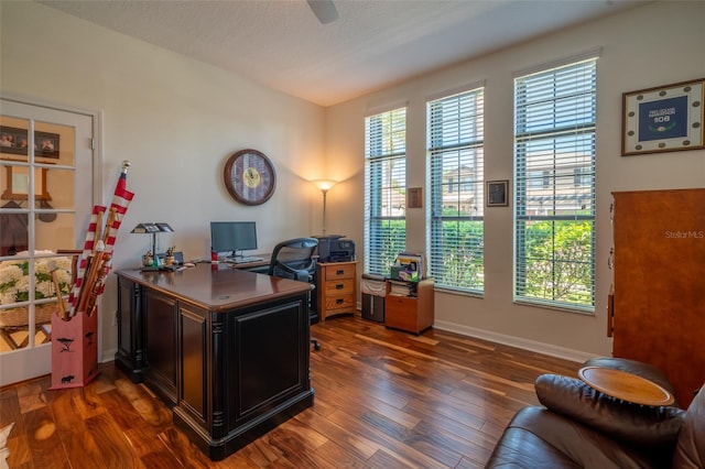 office featuring baseboards, dark wood-type flooring, a ceiling fan, and a textured ceiling