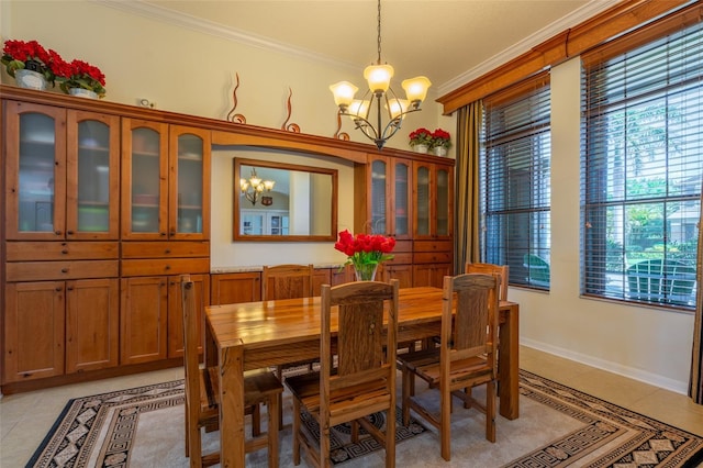 dining space featuring light tile patterned floors, a notable chandelier, crown molding, and baseboards