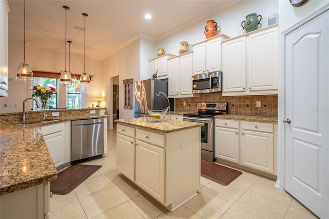 kitchen with backsplash, a kitchen island, crown molding, stainless steel appliances, and a sink