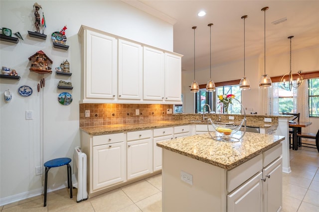 kitchen with backsplash, a peninsula, and crown molding