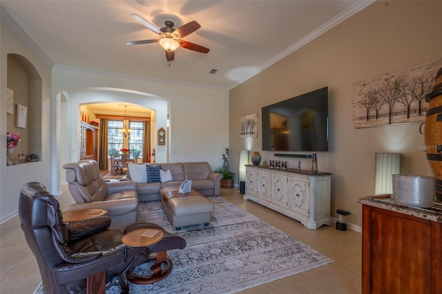 living area featuring light tile patterned floors, arched walkways, a ceiling fan, and crown molding