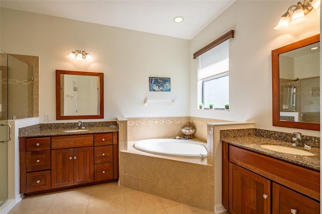 full bathroom with a sink, a stall shower, and tile patterned flooring