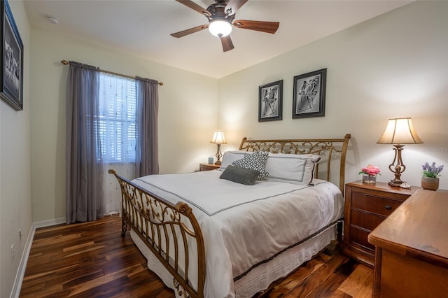 bedroom with baseboards, dark wood-type flooring, and ceiling fan