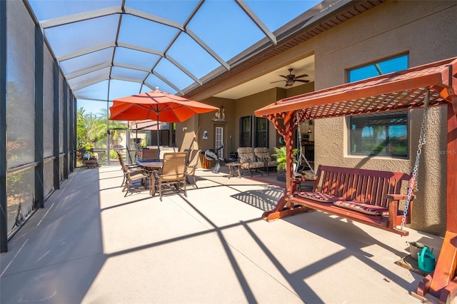 view of patio / terrace featuring glass enclosure, an outdoor living space, outdoor dining area, and ceiling fan