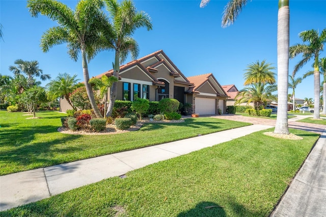 view of front of house featuring stucco siding, concrete driveway, a front lawn, a garage, and a tiled roof