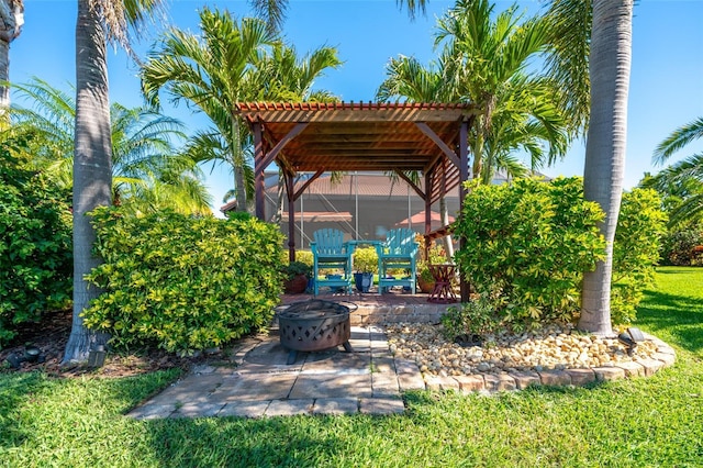 view of patio featuring a fire pit and a lanai