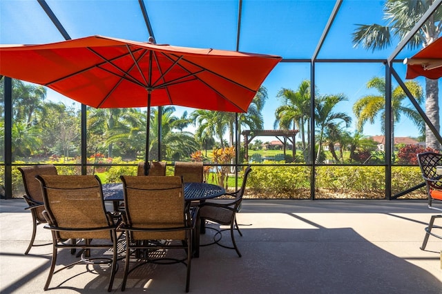 view of patio / terrace featuring a lanai and outdoor dining area