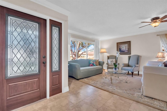 foyer with baseboards, crown molding, and a ceiling fan