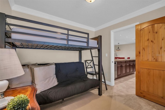 bedroom featuring a textured ceiling, baseboards, and ornamental molding