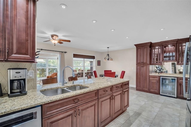 kitchen featuring a sink, light stone counters, stainless steel dishwasher, wine cooler, and decorative backsplash