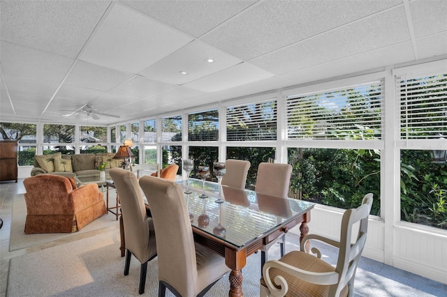 sunroom featuring a paneled ceiling and a ceiling fan