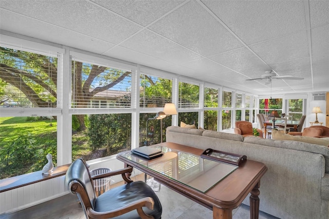 sunroom with a paneled ceiling and a ceiling fan