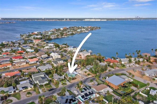 drone / aerial view with a water view and a residential view