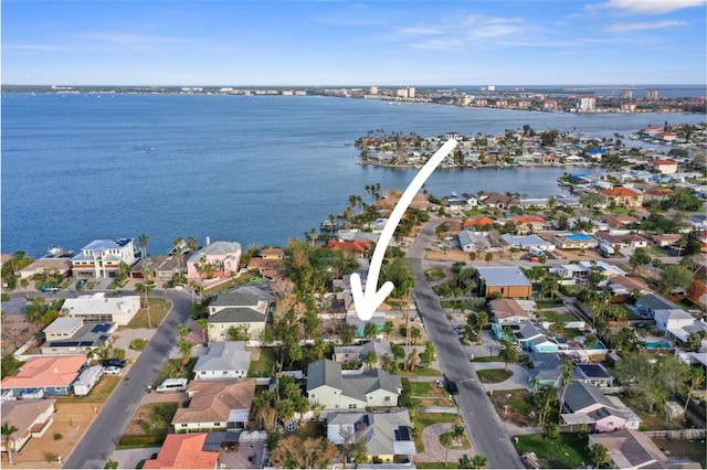 drone / aerial view featuring a residential view and a water view