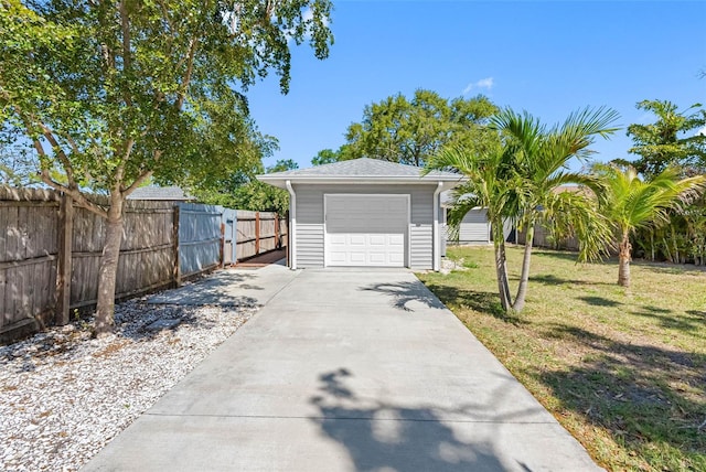 detached garage with driveway and fence