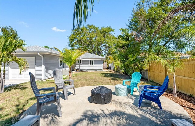 view of patio featuring a garage and fence