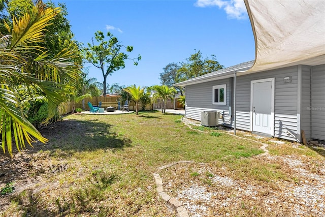 view of yard with a patio, central AC unit, and fence private yard