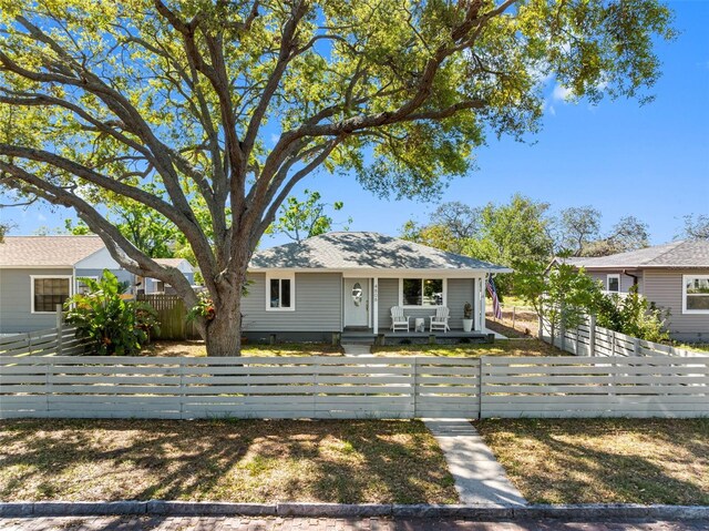 view of front of property with a porch and a fenced front yard