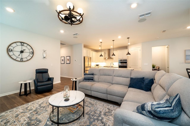 living area with recessed lighting, visible vents, baseboards, and dark wood-style floors