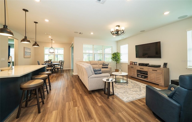 living room featuring recessed lighting, plenty of natural light, and dark wood-type flooring