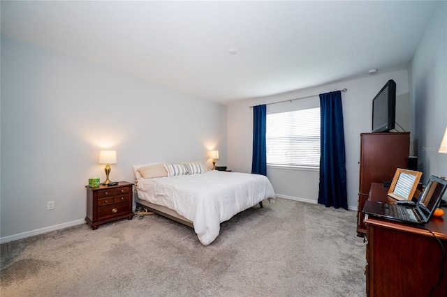 carpeted bedroom with baseboards