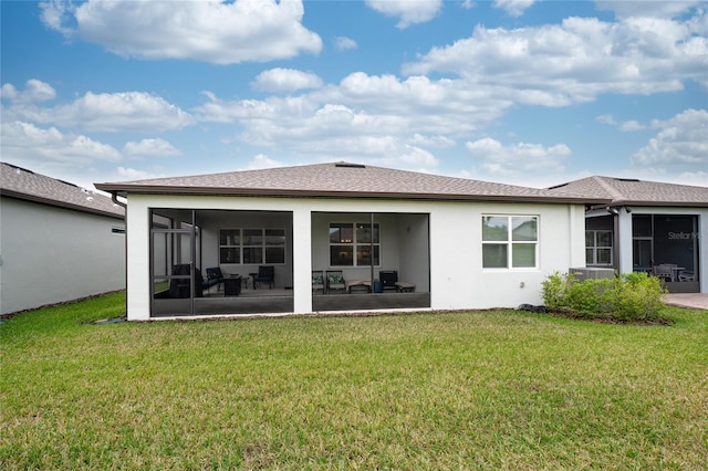 rear view of property featuring stucco siding, a lawn, a shingled roof, and a sunroom