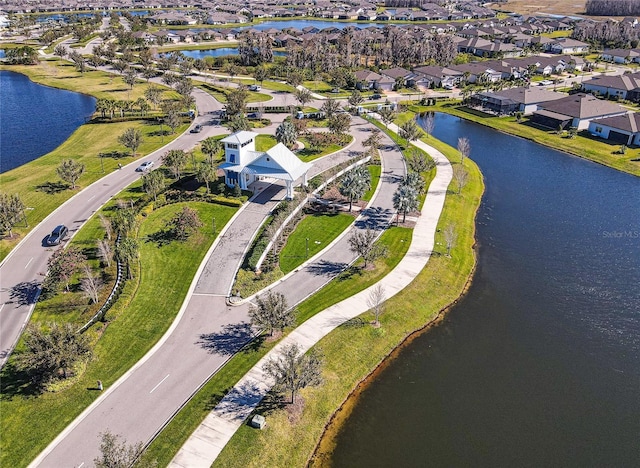 drone / aerial view featuring a residential view and a water view