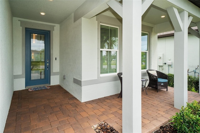 view of exterior entry with stucco siding