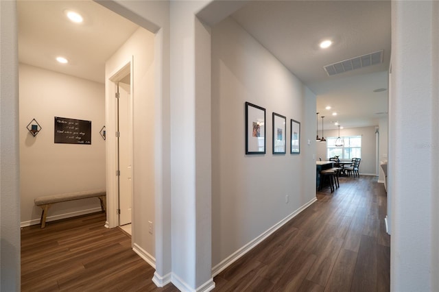 hallway with recessed lighting, dark wood-style floors, visible vents, and baseboards