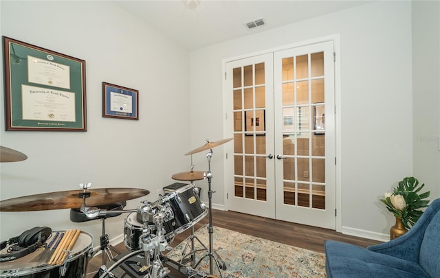 office space with french doors, baseboards, visible vents, and wood finished floors