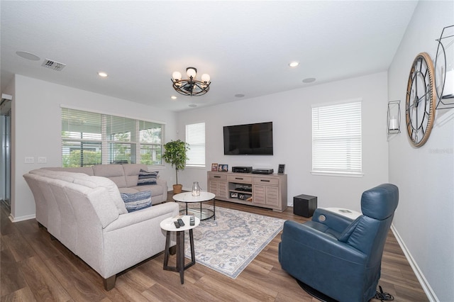 living area with visible vents, a notable chandelier, wood finished floors, recessed lighting, and baseboards