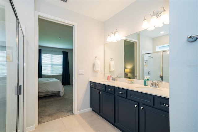 full bath with a stall shower, ensuite bathroom, a sink, tile patterned flooring, and double vanity