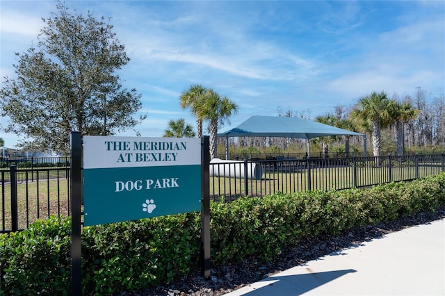 view of home's community featuring fence