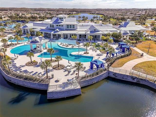 pool with a residential view, a patio, and a water view