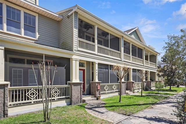 townhome / multi-family property with a porch, ceiling fan, and a sunroom