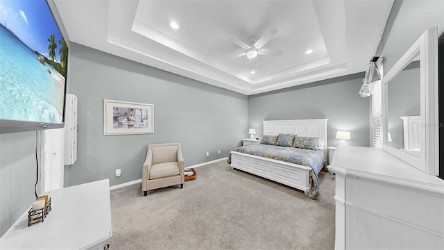 carpeted bedroom with baseboards, multiple windows, a tray ceiling, and recessed lighting